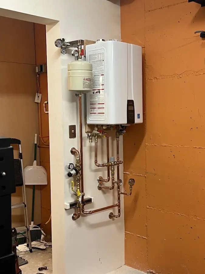 Plumbing technician inspecting water heater connections in Bridgewater Town